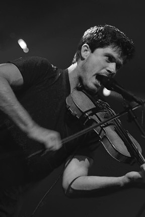 Musician Seth Lakeman performing, playing the fiddle while singing, at the Hebridean Celtic Festival (HebCelt) in Stornoway, Isle of Lewis.