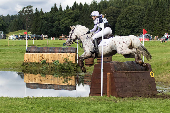 Jockey Eleanor Gudgin jumping with her horse at the Blair Castle Horse Trials in Blair Atholl, Perthshire, Scotland.