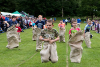 Action photo of children taking part in a traditional sack race at the Kenmore Highland Games, Perthshire (Scotland).
