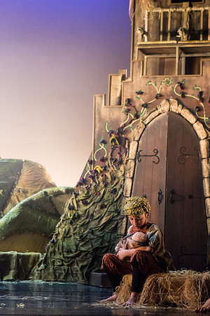 A young community cast member holds a baby during a performance of Rumpelstiltskin by Ballet Lorent at Pitlochry Festival Theatre, Perthshire (Scotland).