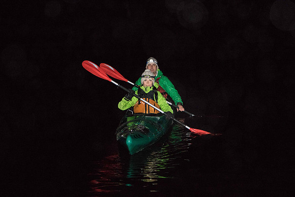 Picture shows two people in a canoe in the dark on Loch Tummel, Perthshire (Scotland).