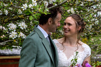 Newly wed couple underneath cherry blossom tree